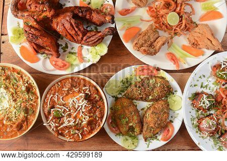 Assorted Indian Food On Wooden Background. Dishes And Appetizers Of Indian Cuisine