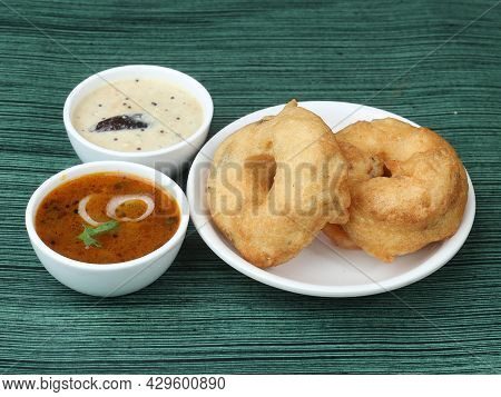 Indian Fried Snack Medu Vada With Sambar And Coconut Chutney In Plate On Rustic Wooden Background, S