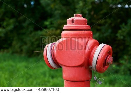 Red Fire Hydrant In City Park, Close Up. Preventive Measures Against Urban Fires