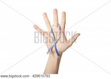 Blue Awareness Ribbon In Hand. Symbol Of Men Health, Childhood Cancer Or Child Abuse Prevention. Whi