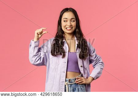 Portrait Of Smiling Awkward Cute Girl, Asian Female Have Little Effort, Show Something Small, Tiny S