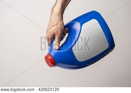 A Male Hand Holging A Blue Kitchen Detergent Bottle With Closed Cap, Lable Selection Path Included.