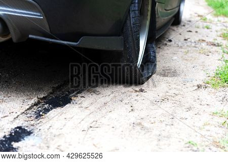 Punctured Wheel Of A Modern Car On The Road. Car Tire Puncture.