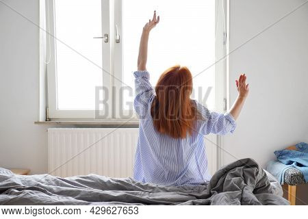 Young Woman Stretching After Waking Up And Getting Out Of Bed