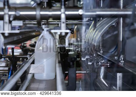White Plastic Gallons Or Bottle On The Production Line Of The Conveyor At Filling Machine In The Fac