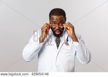 Healthcare, Medicine And Hospital Treatment Concept. Impressed And Surprised African-american Doctor