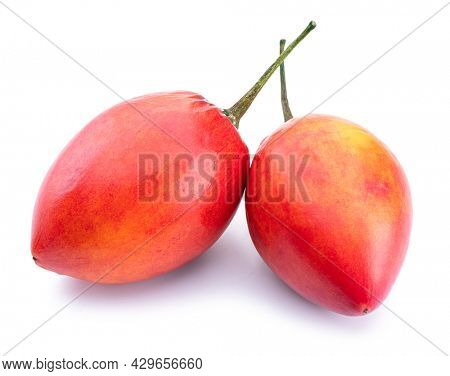 Two ripe tamarillo fruits isolated on a white background.