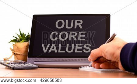 Our Core Values Symbol. Tablet With Words 'our Core Values'. Businessman Hand With Pen, House Plant.