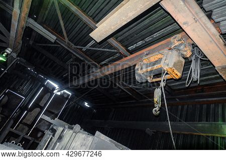 Overhead Traveling Cathead With Steel Hook On Monorail In Industrial Room. Steel Slings.