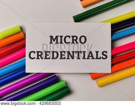 Top View Phrase Micro Credentials On White Card With Colorful Pencils. Education Concept.