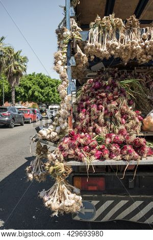 Fresh garlic for sale from the truck on the farmers market in Sicily, Italy