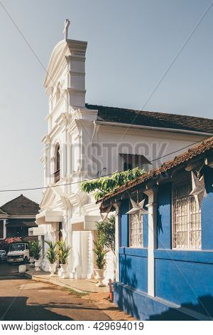 Picturesque narrow street in Fontainhas district with old Portuguese christian church. Fontainhas is an old Latin Quarter in Panjim, capital city of the state of Goa, India