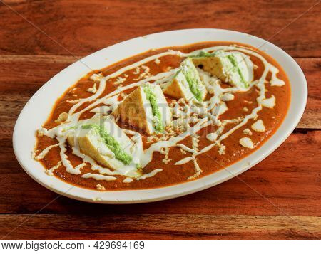Paneer Pasanda, Is A Famous Indian Dish, Served Over A Rustic Wooden Background, Selective Focus