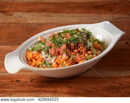 Bhel Puri, A Famous Midday Snack In India, Served Over A Rustic Wooden Background, Selective Focus