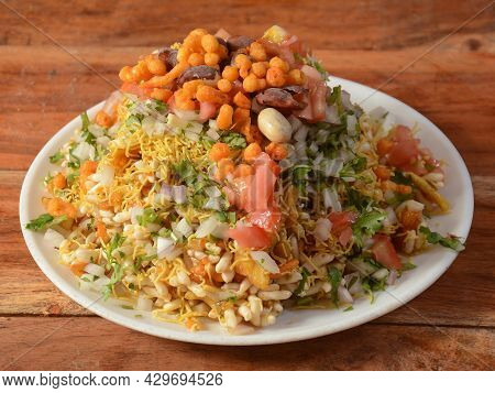 Bhel Puri, A Famous Midday Snack In India, Served Over A Rustic Wooden Background, Selective Focus