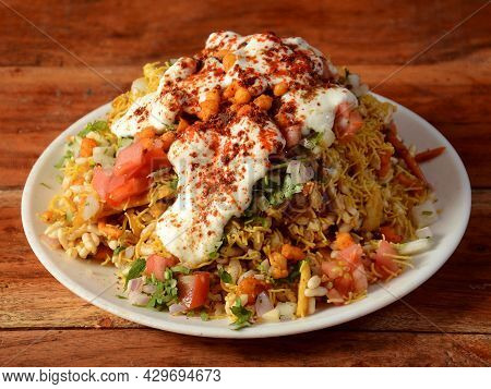 Dahi Bhel Puri, A Famous Midday Snack In India, Served Over A Rustic Wooden Background, Selective Fo