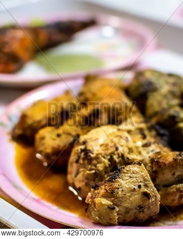 A Selective Focus Image Of A Platter Of Chicken Reshmi Kebab And Chicken Tikka Kebab.