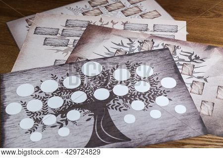 Blank Family Tree Charts On Wooden Table, Closeup
