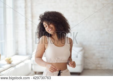 A Happy, Cheerful Young Mixed-race Woman Dancing Alone