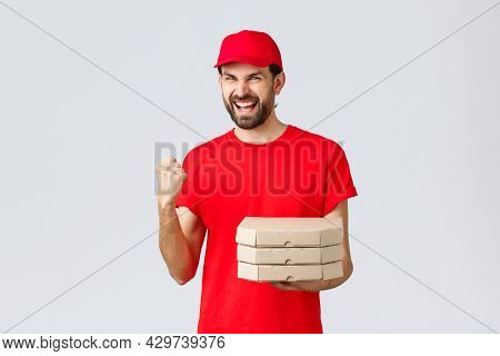 Food Delivery, Quarantine, Stay Home And Order Online Concept. Enthusiastic Courier In Red T-shirt A