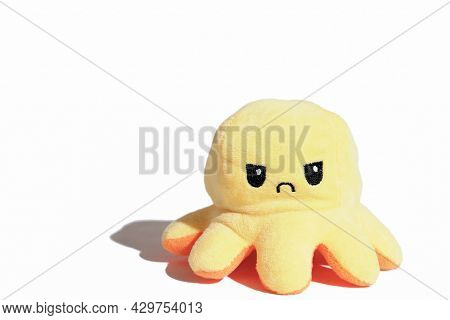 Yellow Angry Toy Octopus Isolated On White Background. Sad Or Moody Kids Concept. Children Agressive