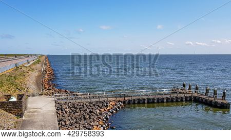 Small Jetty Between Stones With Part Of The Causeway At Afsluitdijk With The Lake Ijssel Created By 