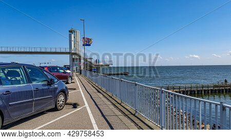 Ijsselmeer In The Netherlands. April 17, 2021. Cars Parked In Afsluitdijk, Stairs, A Bridge, Flags A