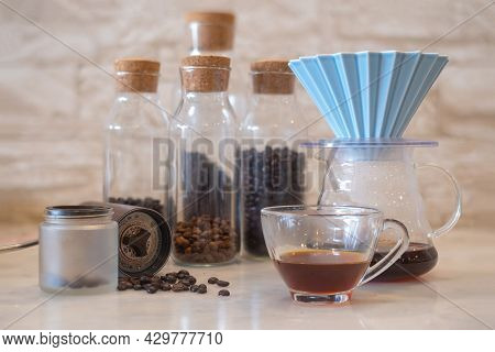 A Cup Of Coffee With Coffee Drip With Origami Dripper And Comandante Coffee Hand Grinder