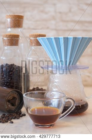 A Cup Of Coffee With Coffee Drip With Origami Dripper And Comandante Coffee Hand Grinder