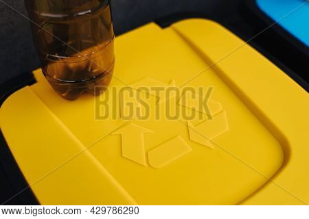 Plastic Bottle On Yeallow Colour Recycling Bin