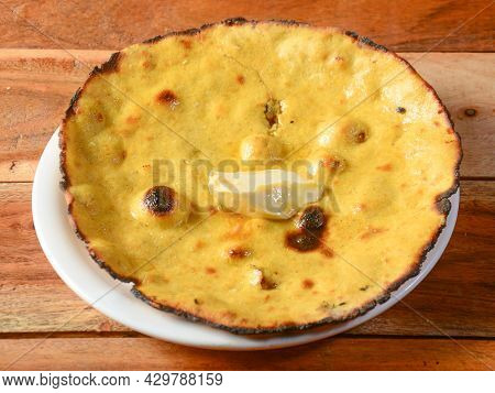 Makke Di Roti, Isolated Over A Rustic Wooden Background, Selective Focus