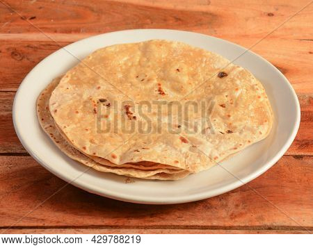 Phulka, Isolated Over A Rustic Wooden Background, Selective Focus