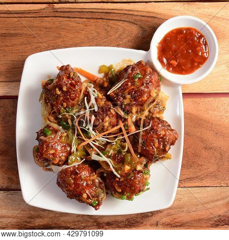 Assorted Indian Food Honey Chilli Chicken On Wooden Background. Dishes And Appetizers Of Indian Cuis
