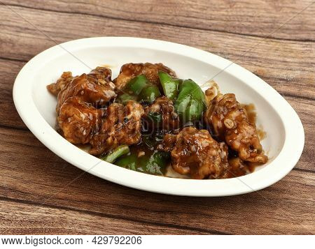 Gobi Manchurian, Popular Indo-chinese Food Made Of Cauliflower Florets, Served In A White Plate Over