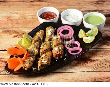 Seekh Kabab - Pakistani Spicy Grilled Ground Meat Skewers, Served Over A Rustic Wooden Table, Select