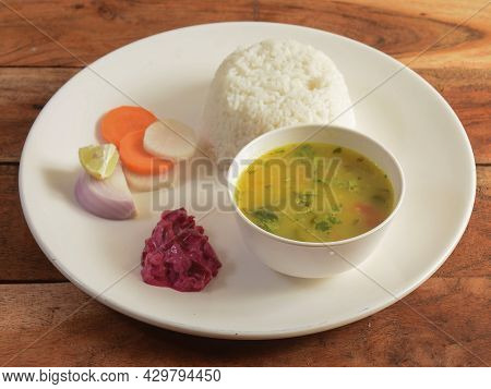 Veg Dal Rice Combo, Made Of Chana Dal, Dalcha Served Over A Rustic Wooden Table. Selective Focus
