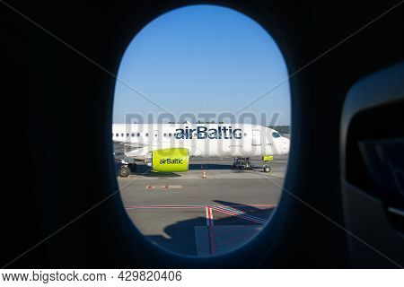 31.06.2021, Riga - Airbaltic Airbus A220 Airplane On Runway From Other Plane Window