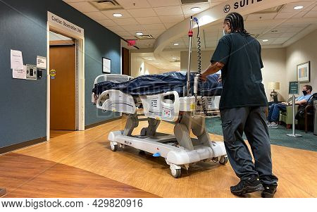 A Piedmont Hospital Worker Moving A Bed To The Cardiac Care Observation Unit In Atlanta, Ga.