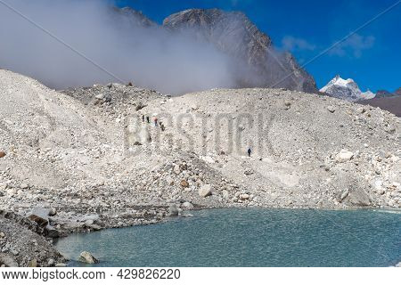 Group Of Trekker Walking On Ngozumpa Glacier The Longest Glacier In The Himalayas Below The Sixth Hi