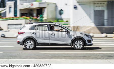 High-speed Motion-blurred Kia Rio X-line On City Street. Silver Kia Kx Cross Fast Driving On The Roa