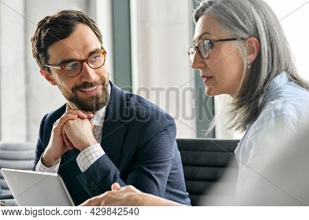 Happy Smiling Bearded Businessman In Eyewear With Clasped Hands Listening To Female Executive Manage