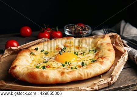 Fresh Delicious Adjarian Khachapuri With Microgreens Served On Wooden Table