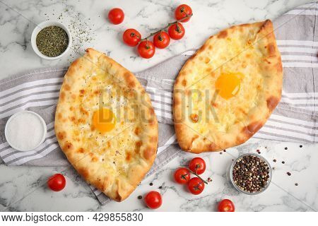 Fresh Delicious Adjarian Khachapuris Served On White Marble Table, Flat Lay