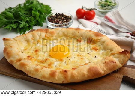 Fresh Delicious Adjarian Khachapuri On White Table, Closeup