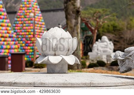 Lotus Statue In Buddhist Temple Songgwangsa, Colorful Lantern Towers On Background, South Korea, Hor