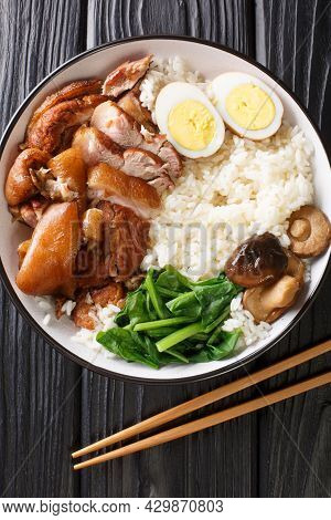 Stewed Pork Leg With Rice, Eggs And Herb Thai Khao Kha Moo Closeup In The Bowl On The Table. Vertica
