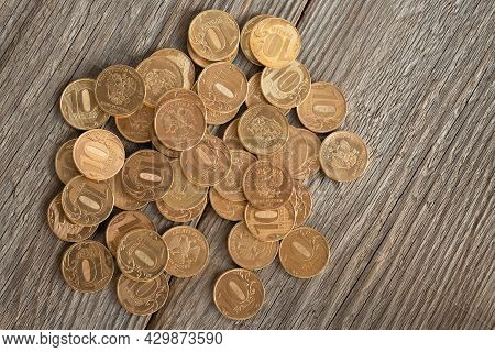 Coins With A Face Value Of 10 Rubles On A Wooden Table, Russian Rubles Background