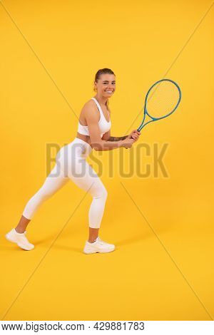Happy Young Girl In Sportswear Running With Racket. Sportswoman. Energetic Woman