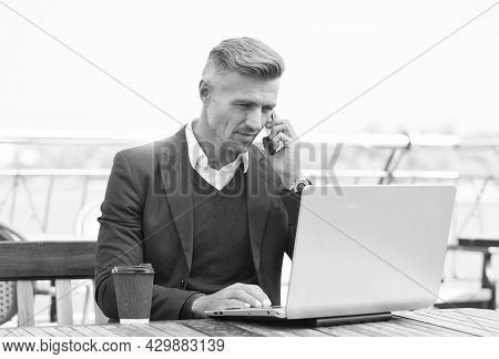 Freelancer Work Laptop Talking On Mobile Phone In Cyber Cafe Outdoors, Freelance