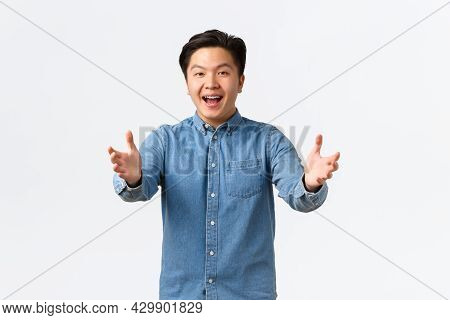 Happy Friendly-looking Asian Male Student Congratulating Friend, Reaching Hands Forward For Hug, Say